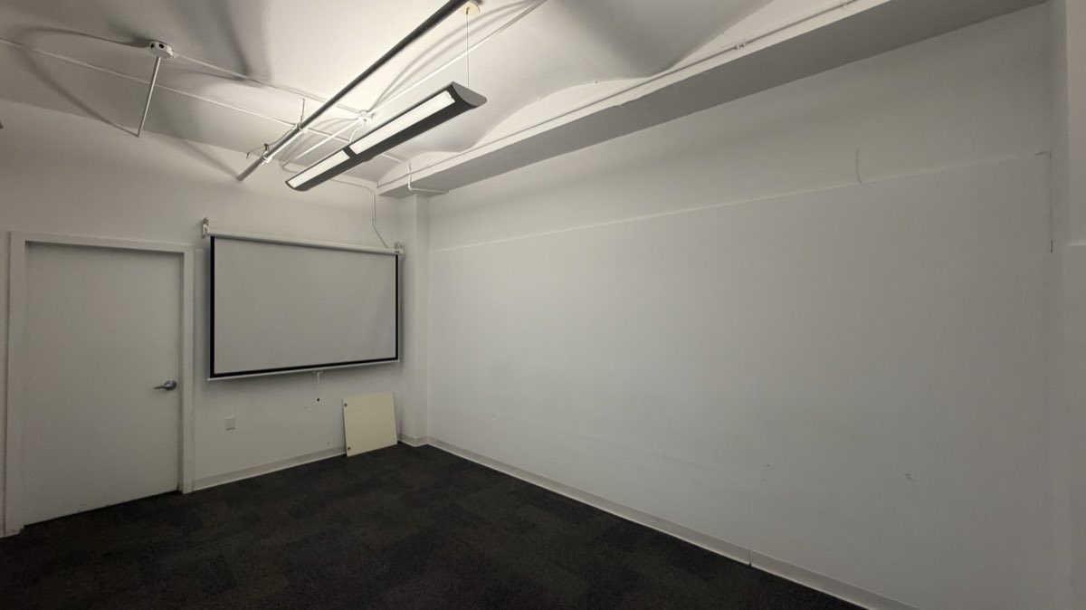 Suite 403 conference room with projection screen